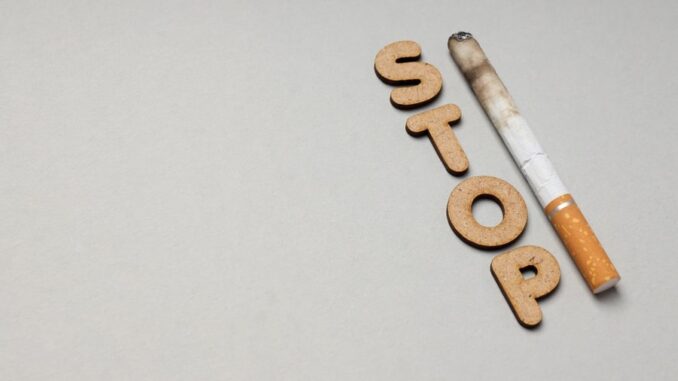 Concept of harm of smoking, text Stop and cigarette, space for text